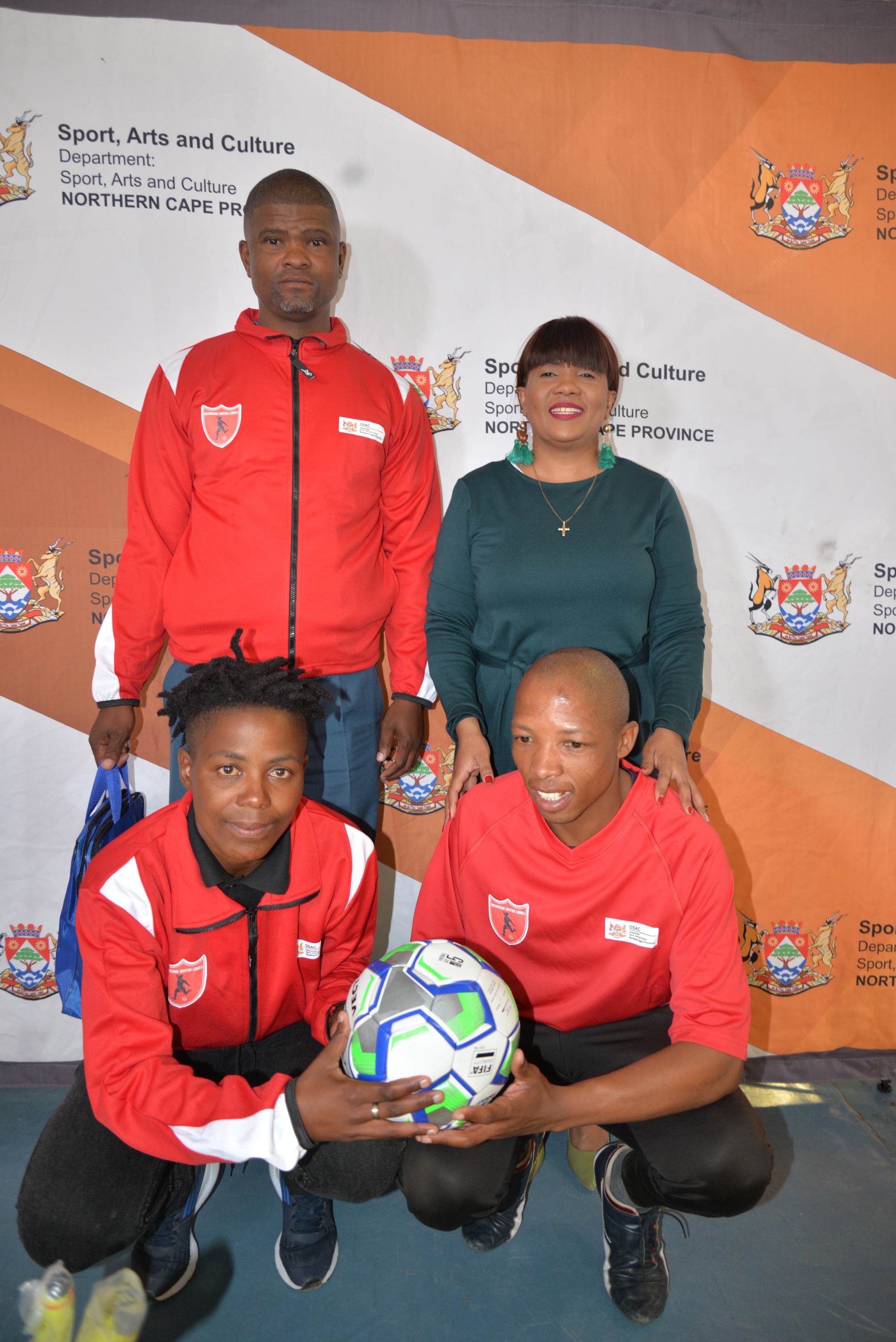 back from left to right  Armichand Amsterdam ( Owner of the Club) MEC for Sport , Arts and Culture Ms Bernice Sinxeve  front from left to right  Noxolo Nongxuso (captain ) and Tshupo Mogajane ( Coach)